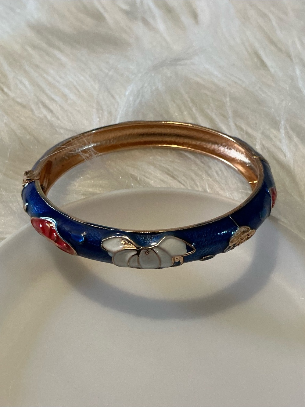 Blue glossy gold-tone bangle bracelet with red/white floral accents